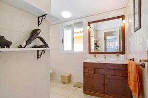 a bathroom with a sink and a mirror at Casa Velázquez in Puerto del Rosario +20 photos