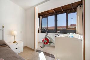 a bedroom with a bed and a desk and a window at Casa Velázquez in Puerto del Rosario