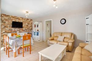a living room with a table and a couch at Casa Velázquez in Puerto del Rosario