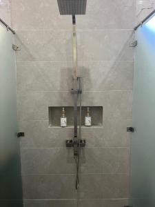 a shower with a shower head in a bathroom at MAHAMAYA Gili Meno in Gili Meno