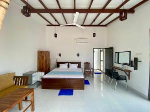 a bedroom with a bed and a table and chairs at Hanka Villa -Ambalangoda in Ambalangoda +30 photos