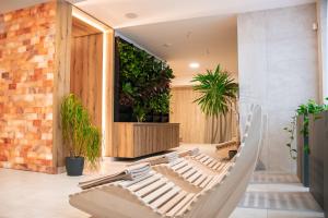a hammock in a room with plants at RM Hotel Wellness & Congress in Prievidza