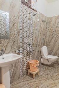a bathroom with a toilet and a sink at Rudra Hotel And Resort ! New ! Mountain ! Kasauli in Kasauli