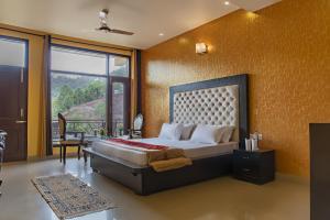 a bedroom with a bed and a large window at Rudra Hotel And Resort ! New ! Mountain ! Kasauli in Kasauli
