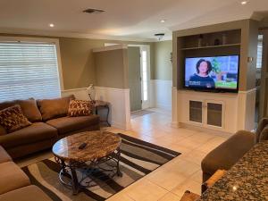 a living room with a couch and a tv at Vacation Home on Alligator Drive in Venice