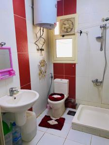 a bathroom with a toilet and a sink at فيلا دوبلكس في لاسيرينا السخنة in Ain Sokhna
