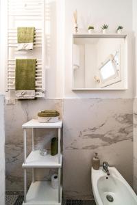 a bathroom with a sink and a mirror and a tub at Marchese 25 Apartments in Bari