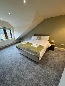 a bedroom with a large bed in a attic at Lovely home with a river view in Mytholmroyd
