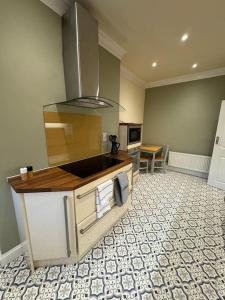 a kitchen with a stove top oven in a room at Lovely home with a river view in Mytholmroyd