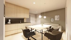 a kitchen and dining room with a table and chairs at Forsthaus Apartment in Holzschlag