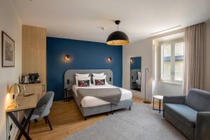 a bedroom with a bed and a blue wall at 9Hotel Cesari in Rome