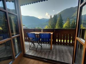 a room with a table and chairs on a balcony at Top location ski-to-door two-bedroom apartment in Bach