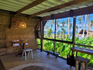 a room with a table and a view of the ocean at Tarzan's House in General Luna
