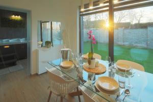 a dining room with a glass table and chairs at Holiday Baranja in Kopačevo