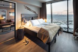 a bedroom with a bed with a view of a city at Basecamp Narvik in Narvik