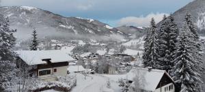 a village covered in snow with mountains in the background at Top location ski-to-door two-bedroom apartment in Bach