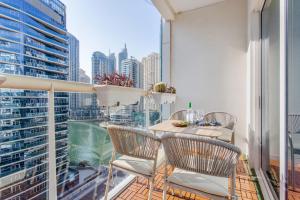 a balcony with a table and chairs and a view of a city at Frank Porter - Marina Views Tower B in Dubai