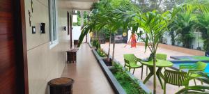 a balcony with a table and chairs and plants at MIRRA ALFASSA VILLA in Auroville