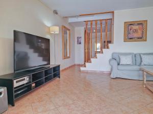 a living room with a flat screen tv and a couch at MEDANO4YOU Montaña Roja Beach House in El Médano