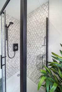 a shower in a bathroom with a glass door at The Burrow in Sion Mills