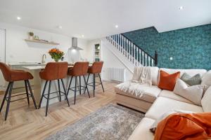 a living room with a couch and a kitchen at The Burrow in Sion Mills