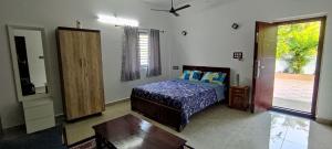 a bedroom with a bed and a table in it at MIRRA ALFASSA VILLA in Auroville