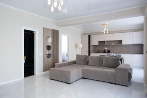 a living room with a couch and a kitchen at Azimuth Hotel By Building Stefan Resort I Nord in Mamaia Sat/Năvodari