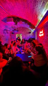 Un groupe de personnes assises à une table dans un club dans l'établissement Le Maje Hostel, à Montpellier