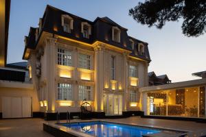 a large building with a swimming pool in front of it at Shoxjahon Hotel - 600 Mbps Internet in Tashkent
