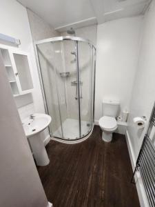 a bathroom with a shower and a toilet and a sink at The New Inn in Thornton Dale