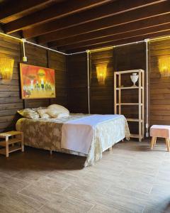 a bedroom with a bed in a wooden room at Vilarejo Hospedagem in Ilha do Mel