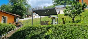 a building with a black roof on top of a hill at Ferienhaus - Bungalow in Sonneberg