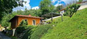 a small house on a hill next to a building at Ferienhaus - Bungalow in Sonneberg