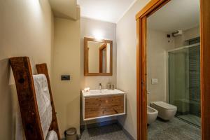 a bathroom with a sink and a toilet and a shower at Maison Checrouit in Courmayeur