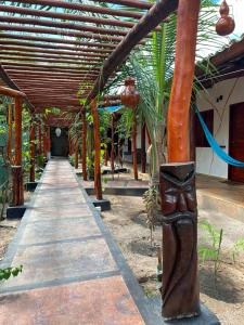 a covered walkway in a building with a wooden roof at Imperio dos Bambus Suites in Jijoca de Jericoacoara