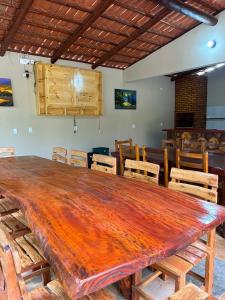 a large wooden table and chairs in a room at Imperio dos Bambus Suites in Jijoca de Jericoacoara