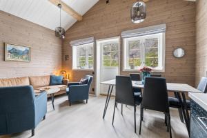 a living room with a table and chairs and a couch at Reine Rorbu, Amaliebua in Reine