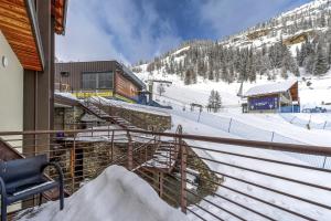 a ski lodge with a snow covered mountain in the background at Maison Checrouit in Courmayeur