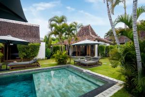 an image of a villa with a swimming pool at Bloom Resort Bali by BaliSuperHost in Canggu
