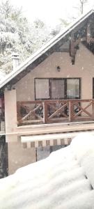 a house covered in snow with a pile of snow at Casa cu nuferi in Chişinău