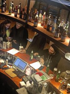 a group of people sitting at a bar with a laptop at 0517 Boutique Hotel in Huangshan Scenic Area