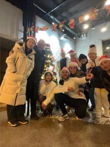 a group of people posing in front of a christmas tree at 0517 Boutique Hotel in Huangshan Scenic Area