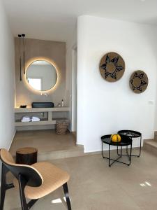 a living room with a table and a mirror at Esperides in Platis Yialos Mykonos