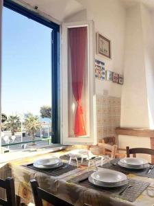 a dining room with a table and a window at Villino Mirella a Marina di Cecina in Marina di Cecina