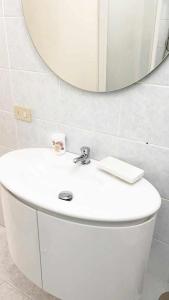 a bathroom with a white sink and a mirror at Villino Mirella a Marina di Cecina in Marina di Cecina