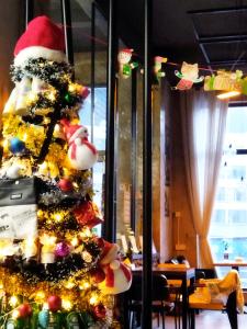 a christmas tree with a santa hat and lights at 0517 Boutique Hotel in Huangshan Scenic Area