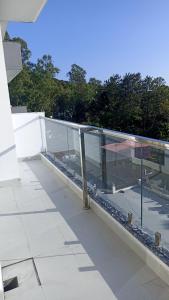 a balcony with glass walls on a building at Blue heron homestay in Dehradun