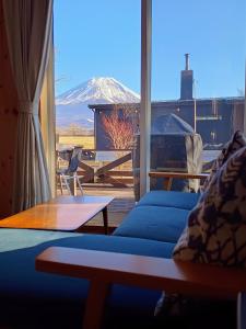 a living room with a view of a snow covered mountain at ヒウチバコ in Fujikawaguchiko