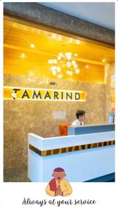 a man sitting at a counter at a restaurant at Hotel Tamarind in Sohāna