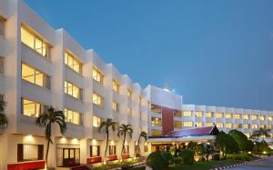 an exterior view of a hotel at night at Centara Life Hotel Mae Sot in Mae Sot